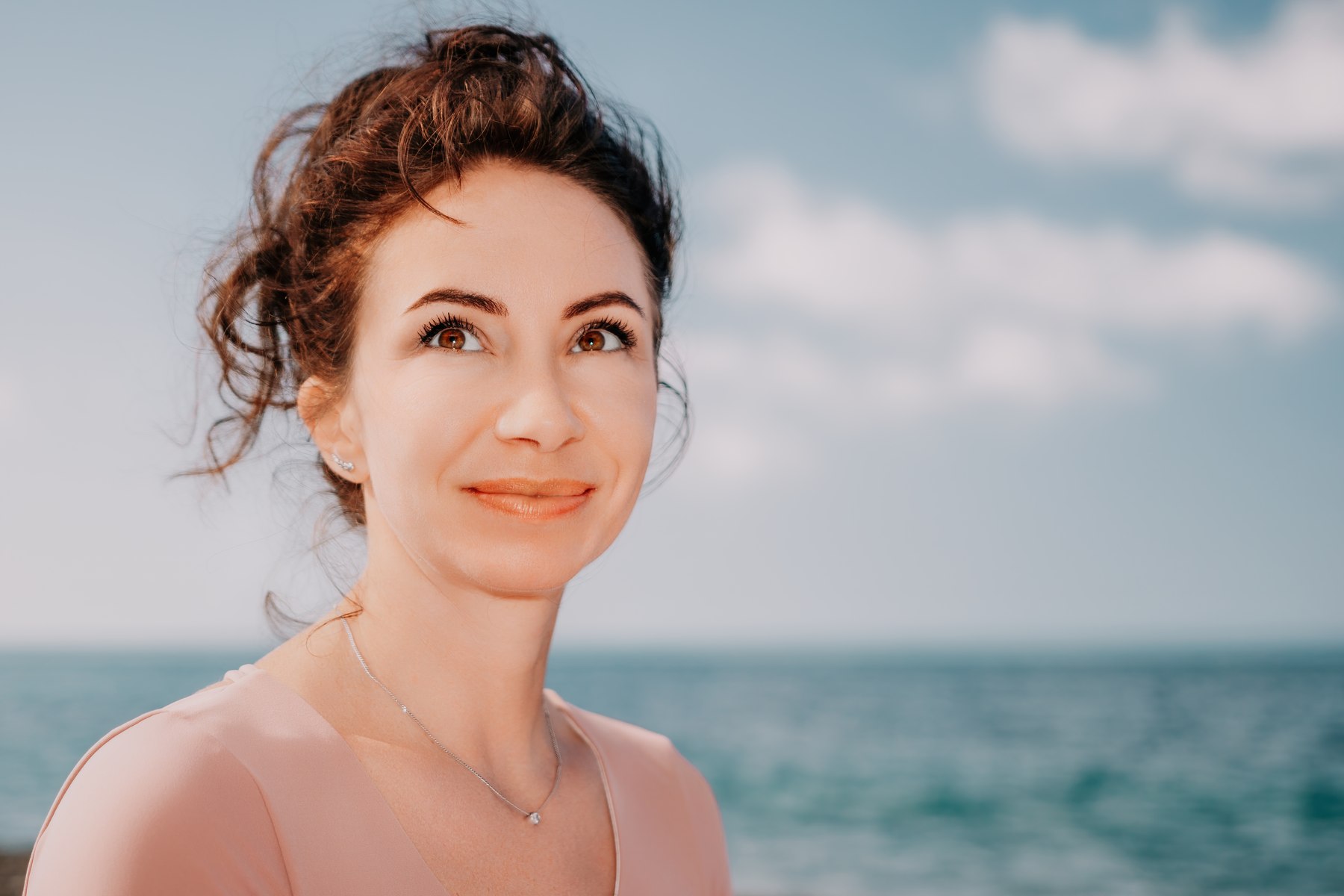 Stock placeholder: a woman by the ocean