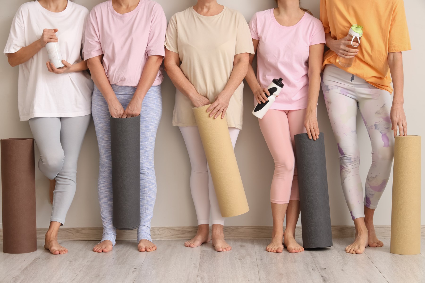 Stock placeholder: women together with exercise mats